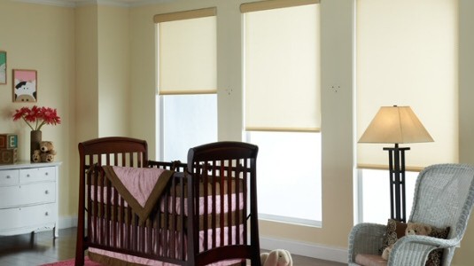 Translucent shades allow the light to filter through, but prevent any actual see-through. This example of a baby's crib room demonstrates the effect.